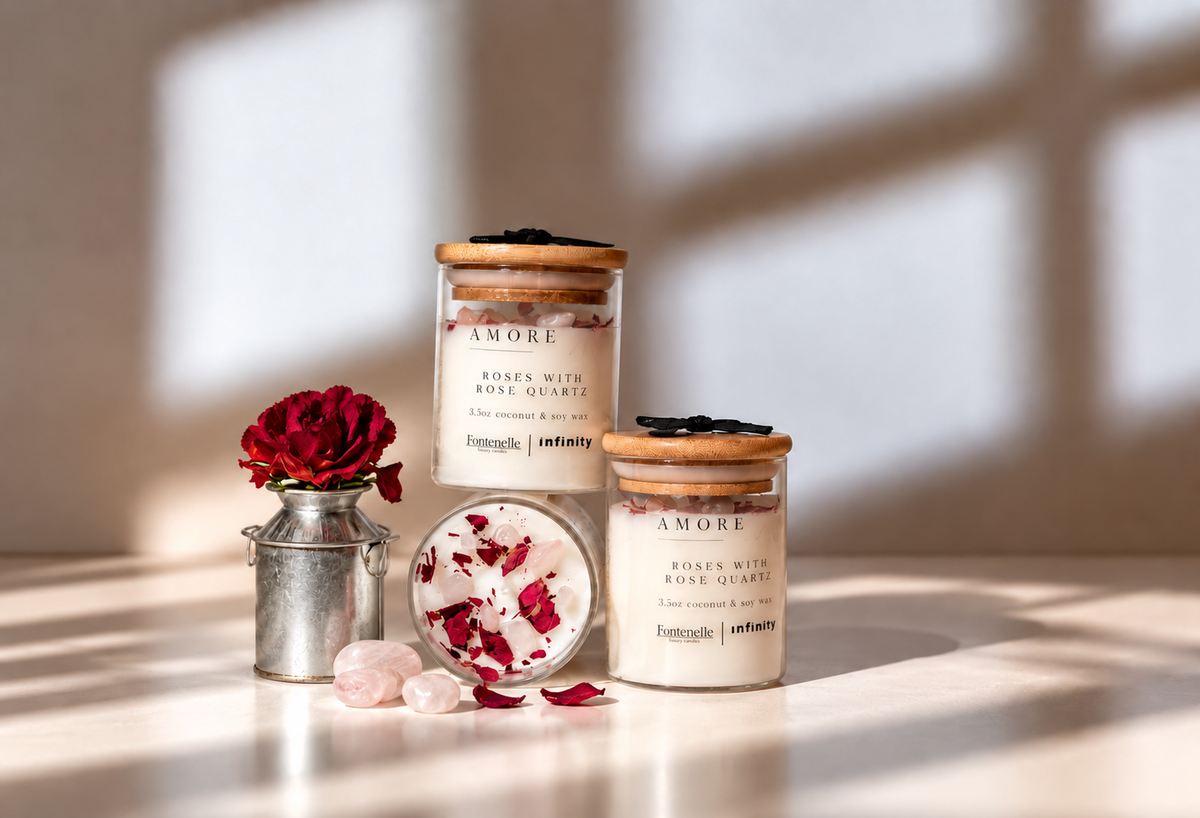 Amore Incanto candles in glass jars, styled with a red rose, petals and rose quartz stones