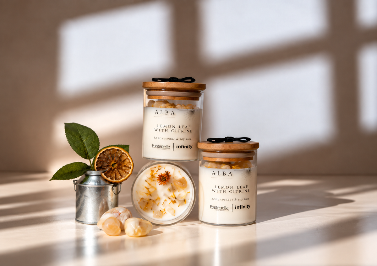 Alba Incanto candles in two glass jar sizes, styled with lemon leaf, dried citrus and citrine stones
