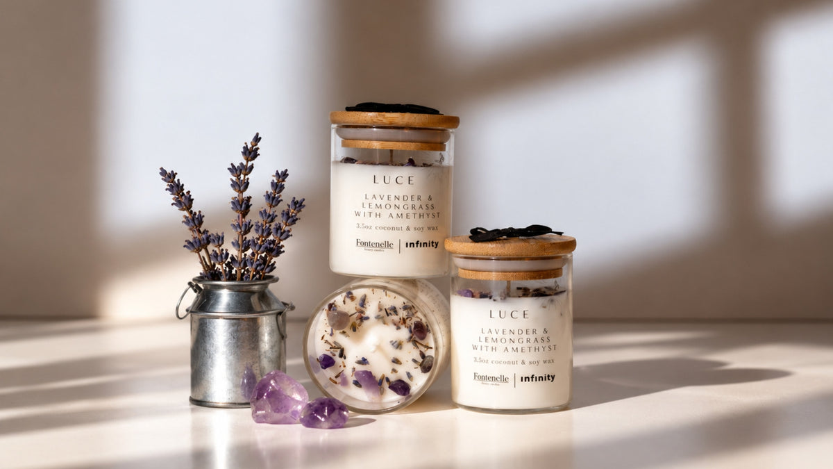 Luce Incanto candles in glass jars, styled with lavender sprigs and amethyst stones