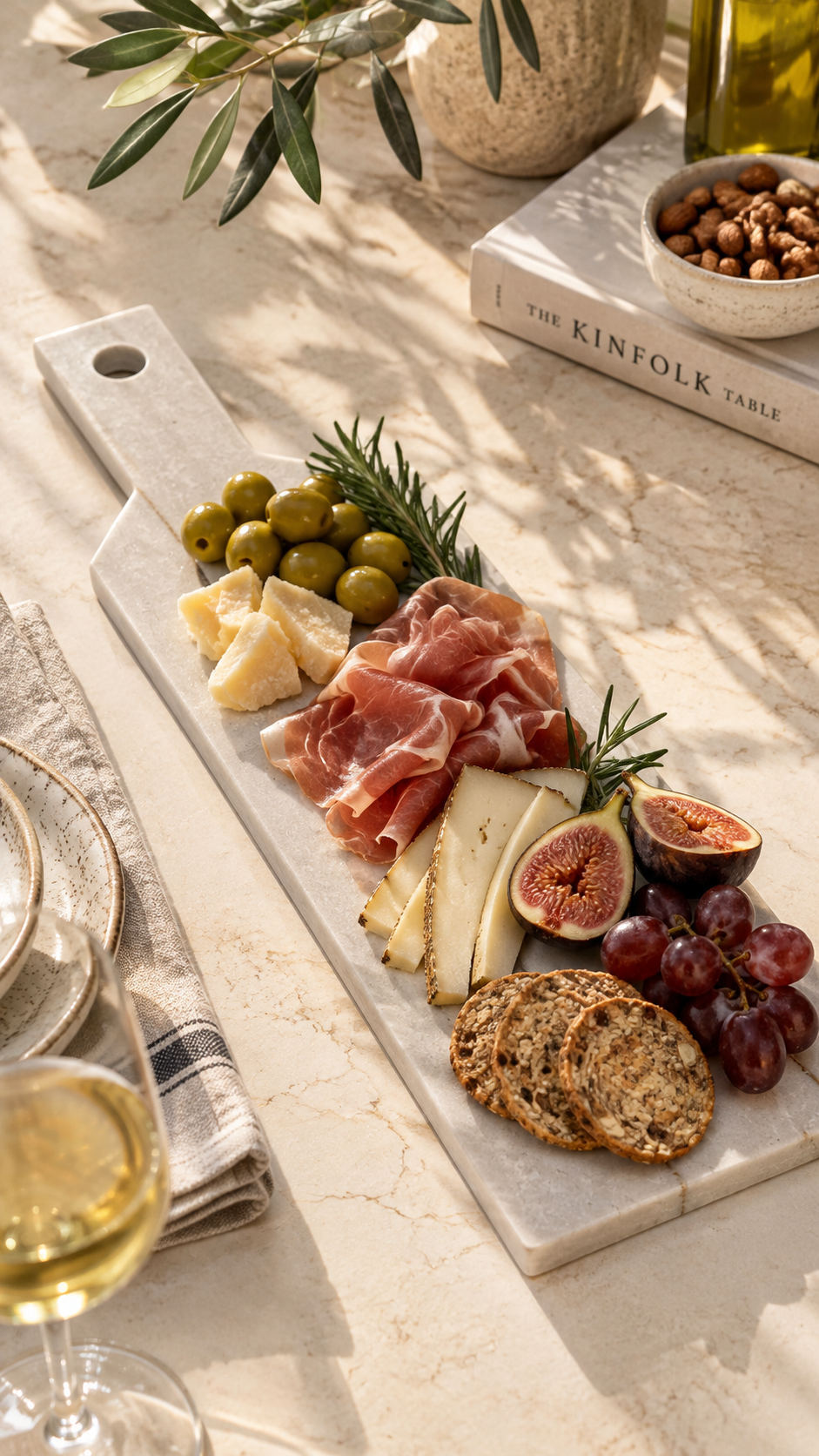 Diamond Quartzite skinny tray styled as a charcuterie board with cheese, prosciutto, fruit and olives
